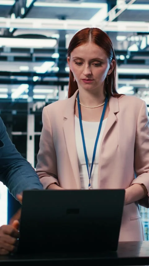 Vertical video Server hub engineering team using laptop to monitor power Stock Footage 330086113