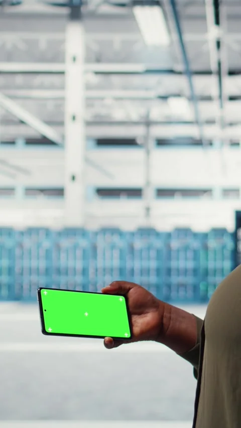 Vertical video Server hub system administrator uses green screen smartphone to Stock Footage 316857854