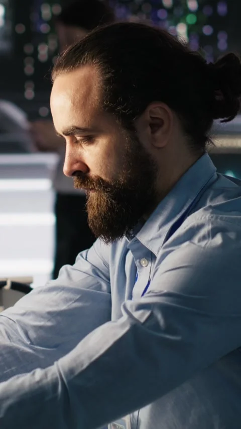 Vertical video Server hub worker arranging desk objects to optimize efficiency Stock Footage 309247362