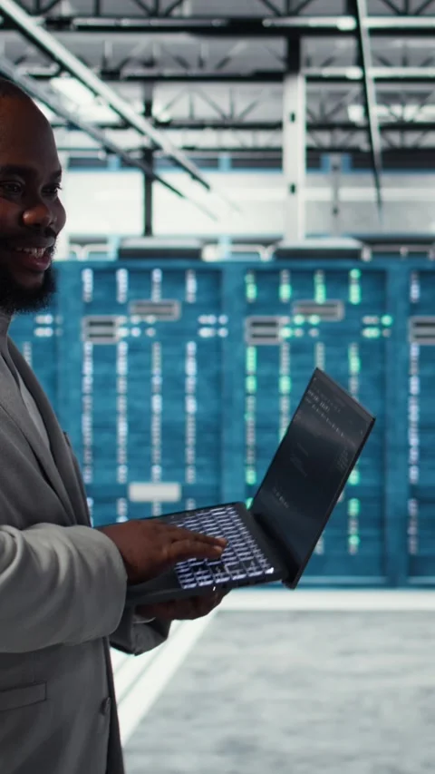 Vertical video Server room engineer deploying new builds to improve uptime using Video stock 311490006