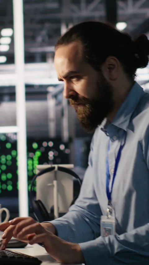 Vertical video Server room IT specialist frustrated by difficult complex tasks Video stock 309486045