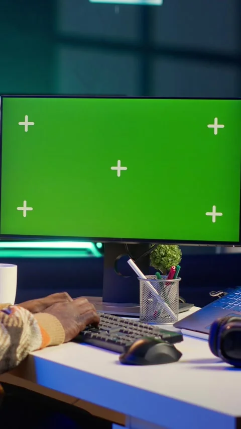 Vertical Video Server technician optimizing program and next to green screen Stock Footage 319573346