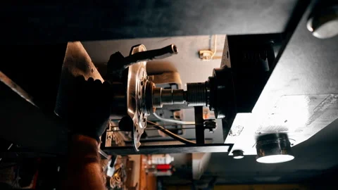 Vertical video in a service station the hands of an auto mechanic work with disk Stock Footage 276110712