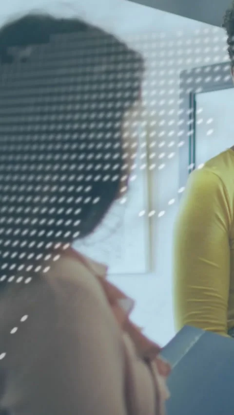 Vertical video: Shifting dotted overlay revealing women trading blue file in Stock Footage 334540832