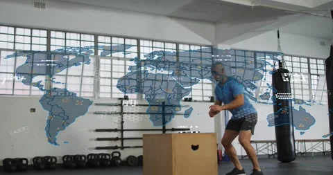 Vertical video: Shifting man stepping off plyo box jumping for power at gym in Stock Footage 334183130