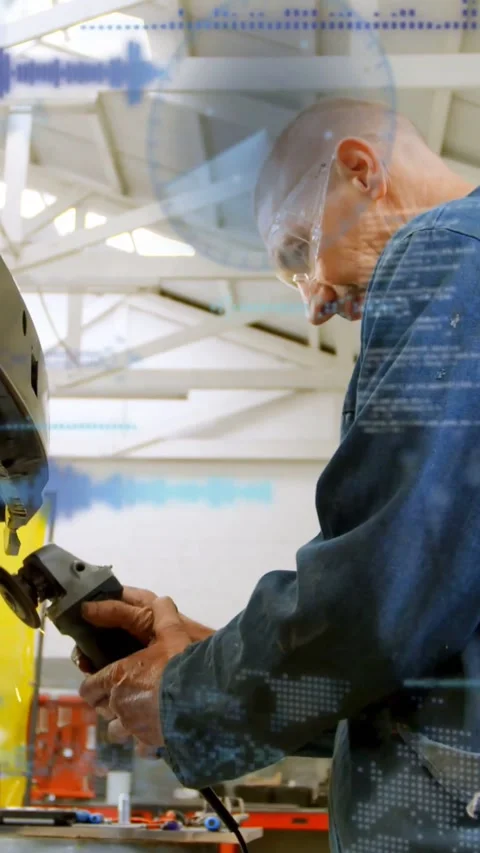 Vertical video: Shop tech checking grinder, grinding metalwork for fit while Stock Footage 334396344