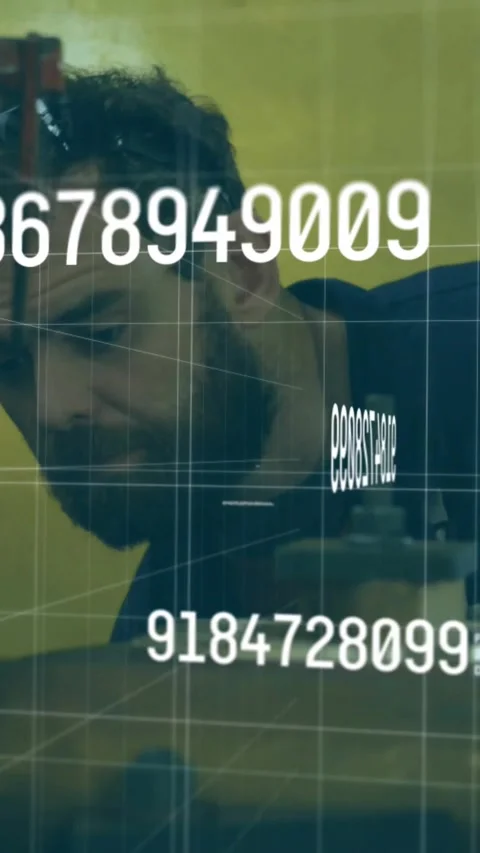 Vertical video: Shop tech tuning earcup leaning checking part, HUD data on clear Stock Footage 330655741