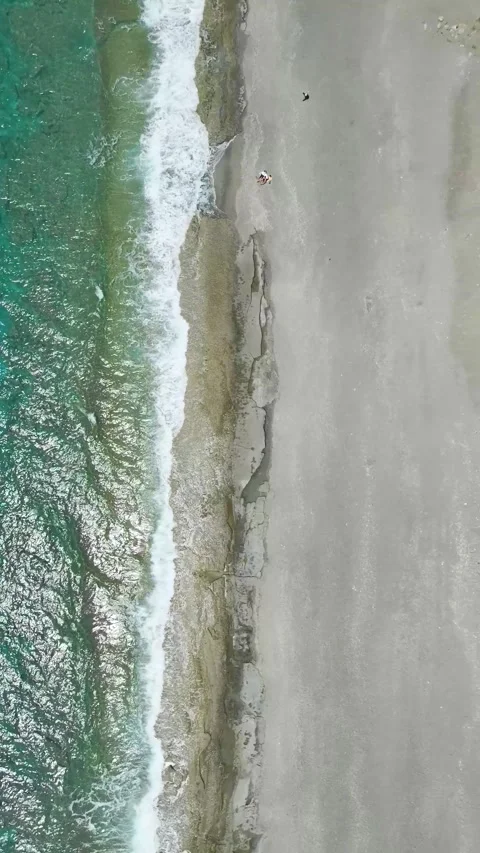 Vertical Video Shoreline with Emerald Water and Beach Setup Stock Footage 341933354