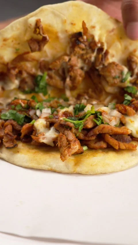 Vertical video, showing the inside of a taco al pastor called gringa Stock Footage 280516798