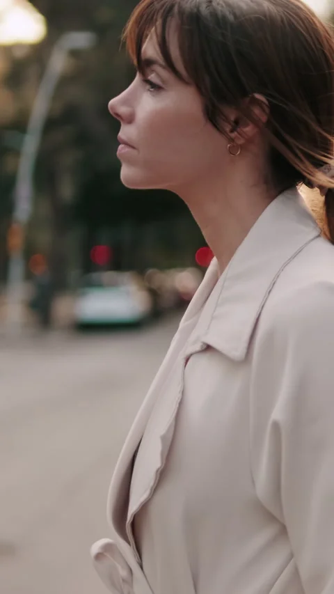 Vertical video, Side view of Contemplative Woman Walking Down City Street Stock Footage 307965639