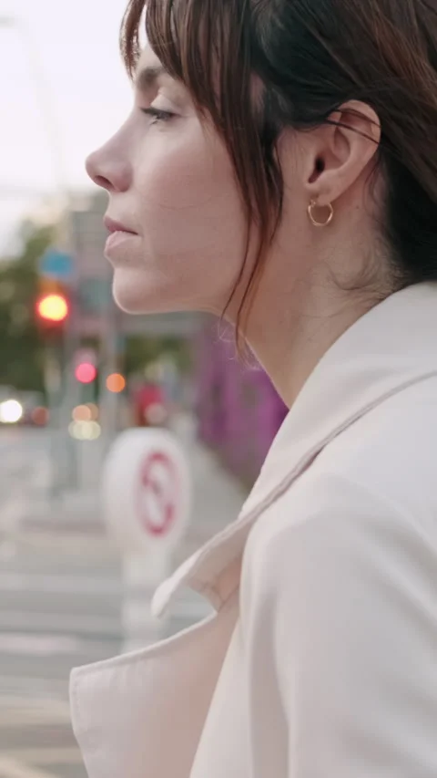 Vertical video, Side view of the Contemplative Woman on a City Street Stock Footage 307965690