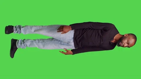 Vertical video: Side view of friendly male model waving at someone on camera Stock Footage 237417648