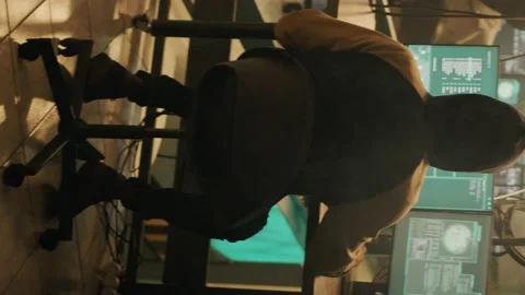 Vertical video: Silhouette of hacker coding encryption to plant trojan virus Stock Footage 228659576