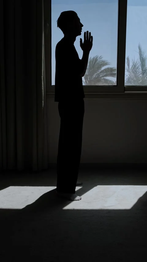 Vertical video of silhouette man praying by window, seeking hope, faith and Stock Footage 346248227