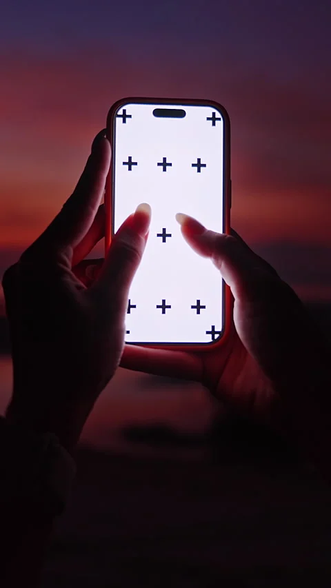 Vertical video. Silhouette of Two Hands Performing Zoom Gesture on Smartphone Wi 動画素材 327408227