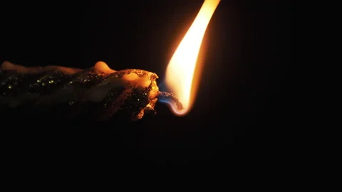 Vertical Video. A Single Candle is Lit on Black Background. Candle Flame in Dark Stock Footage 142274002