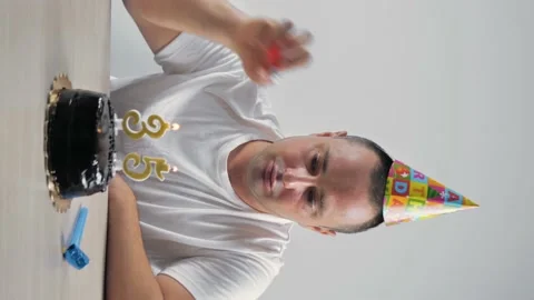 Vertical video. a single man celebrates his 35th birthday, lights candles Stock Footage 160838646