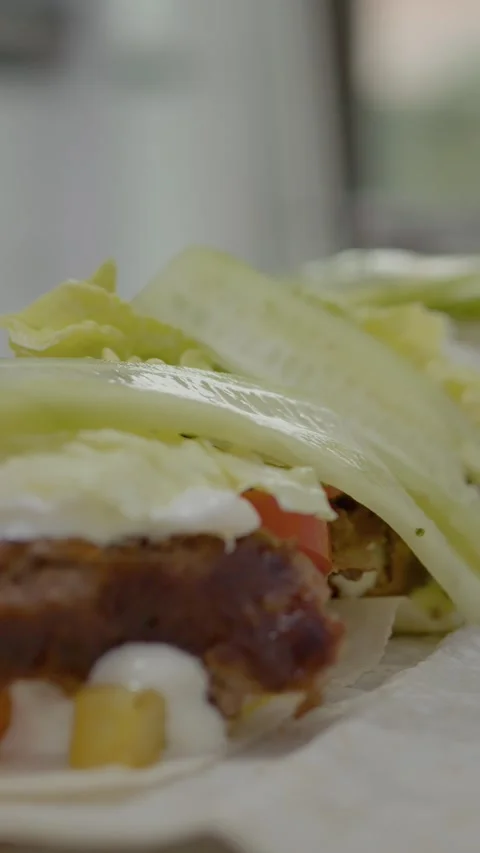 Vertical video Skillful hands prepare fresh kebab with toppings on soft lavash Stock Footage 329626427