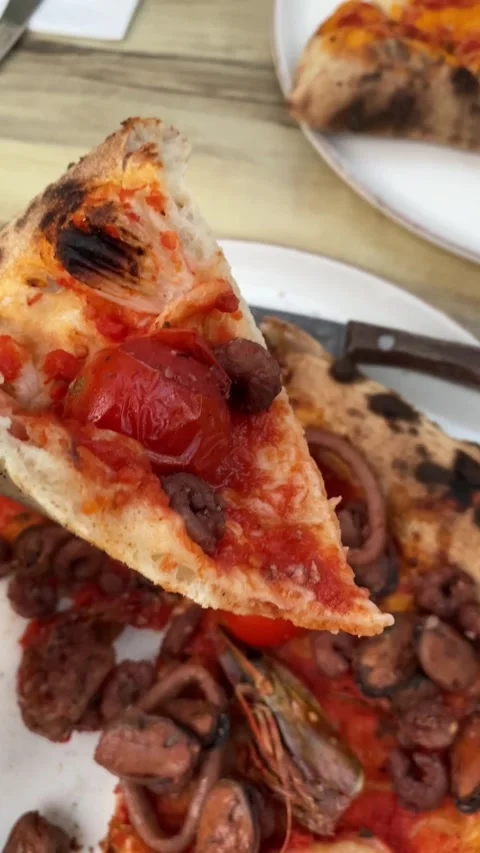 Vertical video, a slice of pizza with seafood in hand Stock Footage 157638452