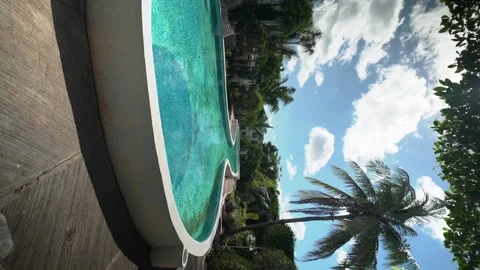 Vertical video - slow motion - beautiful swimming pool with palms trees Stock Footage 172164027