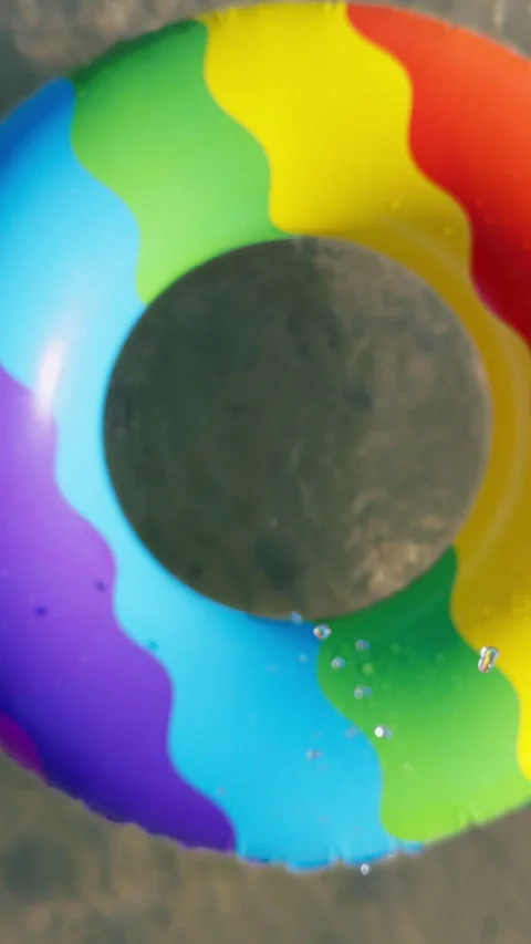 Vertical video. Slow Motion Camera Passing Through the Center of a Colorful Infl Stock Footage 339192432