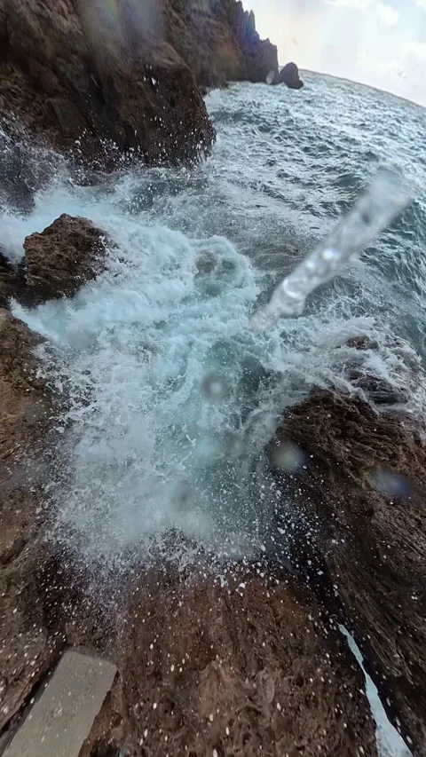 Vertical video. A slow-motion capture of a wave exploding into foam against Stock Footage 293741722