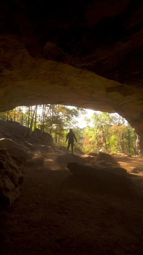 Vertical Video Slow Motion Cave Cavern Girl Standing on Stone Natural Wonder Stock Footage 256050867