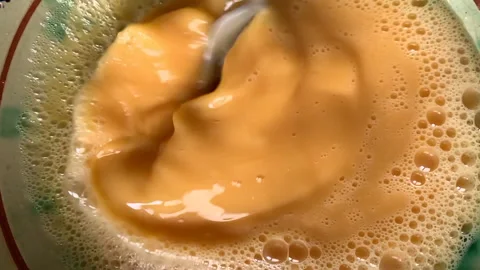 Vertical video. Slow motion of fork beating eggs.Close up. Video stock 220074848