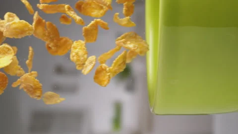 Vertical video: Slow Motion of pouring corn flakes into green bowl at 1000fps. Stock Footage 168387323