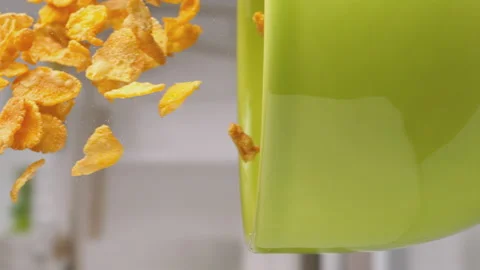 Vertical video: Slow Motion of pouring corn flakes into green bowl at 1000fps. Stock Footage 168398952