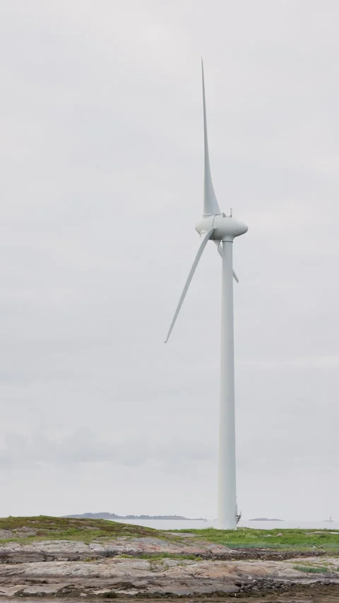 Vertical video of small coastal wind turbine. Video stock 337049116