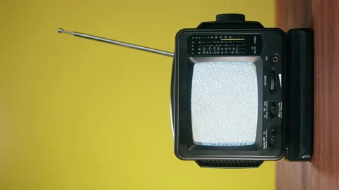 Vertical video of small old television with grey interference screen on yellow 스톡 동영상 169115758