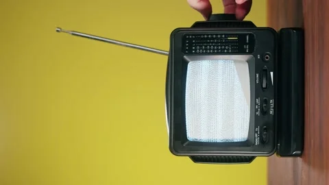 Vertical video of small old television with grey interference screen on yellow Stock Footage 172270367