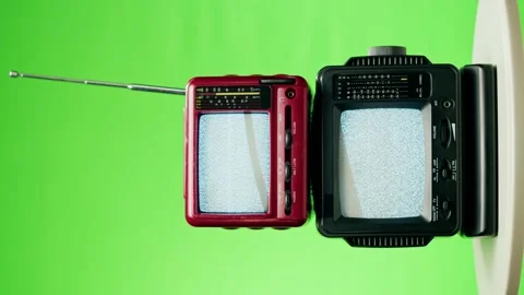 Vertical video of small old televisions with grey interference screen on chroma Stock Footage 169195256