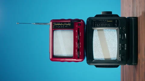 Vertical video of small old televisions with grey interference screen on blue Stock Footage 169734310