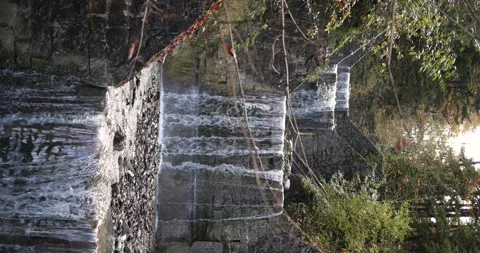 Vertical video of small waterfall located in Swiss Alps. Beautiful sunny day in Stock Footage 221557778