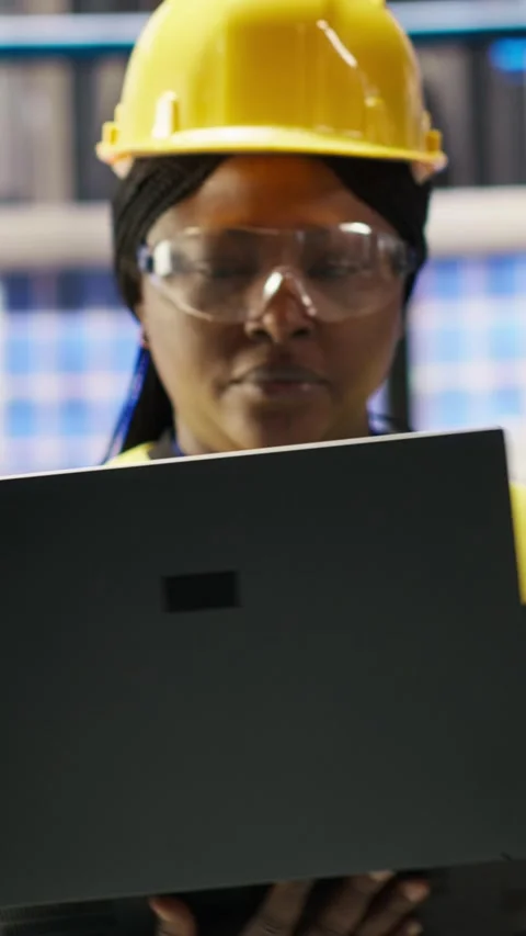 Vertical video Smart factory engineer using laptop to implement automated Stock Footage 307144756