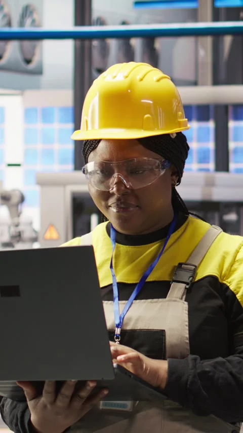 Vertical video Smart factory engineer using laptop to implement automated Stock Footage 307145046