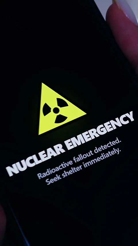 Vertical video. Smartphone Screen Showing Nuclear Emergency Warning Symbol And A Stock Footage 330548051