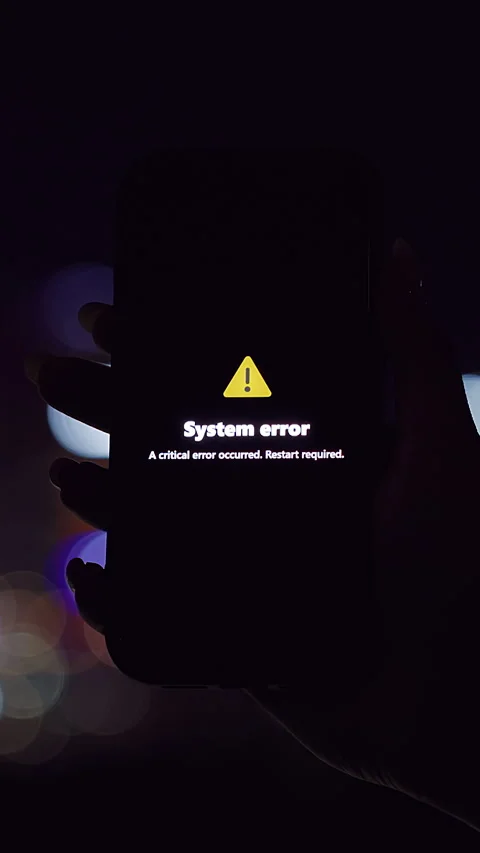 Vertical video. Smartphone Showing System Error Alert with Yellow Triangle Held Stock Footage 323466458