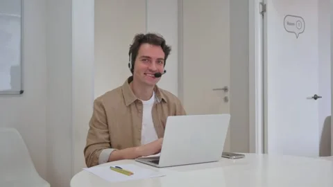 Vertical Video, Smiling Call Center Agent Ready to Assist Video stock 312914053