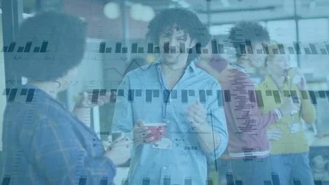 Vertical video: Smiling center man in blue shirt holding red mug on break, data Stock Footage 332867293