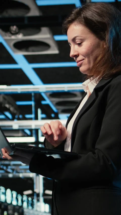 Vertical video Smiling data center female engineer pleased after upgrading AI Stock Footage 329319992