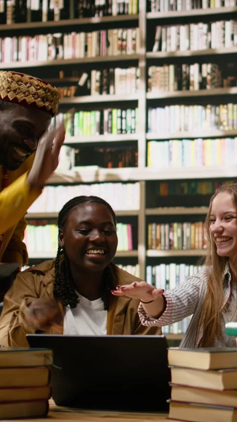 Vertical Video Smiling diverse students stacking hands together in unity at Stock Footage 337529735