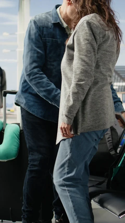 Vertical Video Smiling elderly passengers getting up for boarding plane at gate Stock Footage 344373613