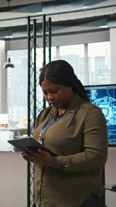 Vertical video Smiling engineer next to office coworkers developing AI software Stock Footage 312707102