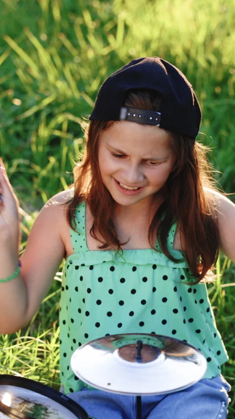 Vertical Video of smiling happy young little girl with long hair playing on the Stock Footage 306234082