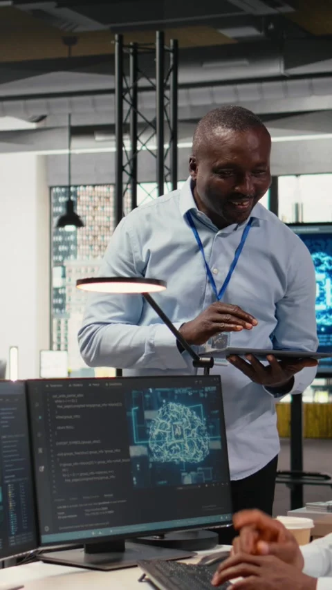 Vertical video Smiling IT staff members in office using AI to optimize company Stock Footage 323028255
