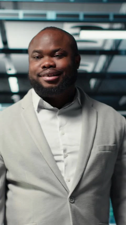 Vertical video Smiling manager in data center doing checkup on hardware to avoid Stock Footage 311547934