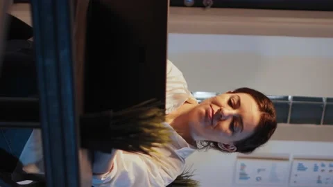 Vertical video: Smiling software developer planning network report on laptop Stock Footage 219701840